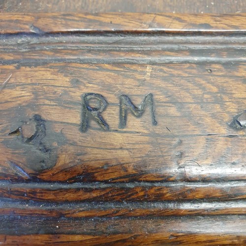 485 - An 18th century oak coffer, with a later carved front, 120 cm wide