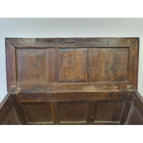 485 - An 18th century oak coffer, with a later carved front, 120 cm wide