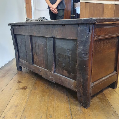 485 - An 18th century oak coffer, with a later carved front, 120 cm wide