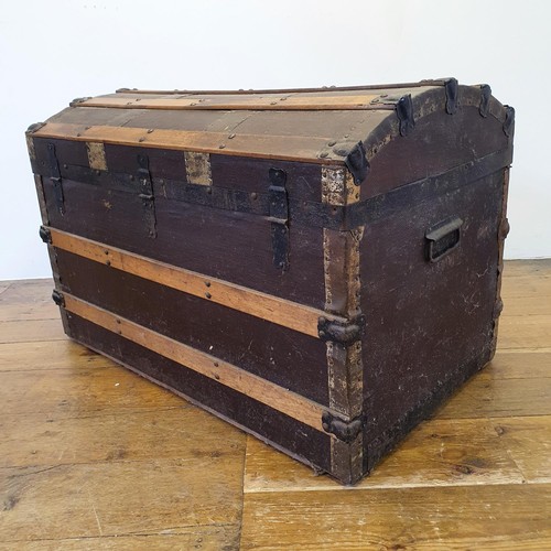 574 - A canvas and oak dome top trunk, 85 cm wide, and a mahogany chest, 107 cm wide (2)