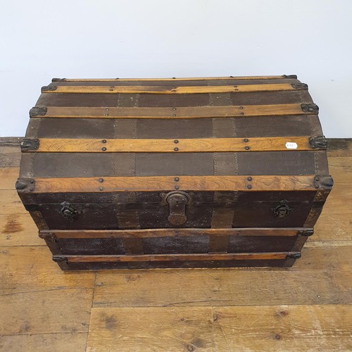 574 - A canvas and oak dome top trunk, 85 cm wide, and a mahogany chest, 107 cm wide (2)