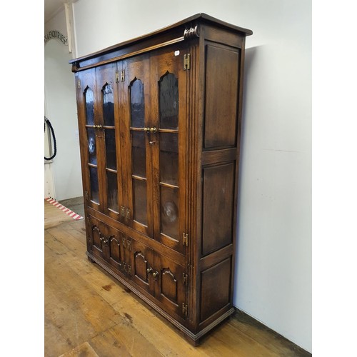 575 - An oak cabinet, having four glazed doors, 134 cm wide