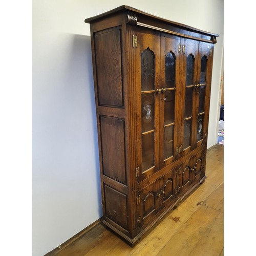 575 - An oak cabinet, having four glazed doors, 134 cm wide