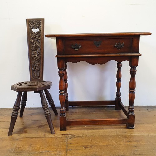 562 - A walnut sideboard, 180 cm wide, and a walnut side table, 73 cm wide, and a carved oak stool (3)