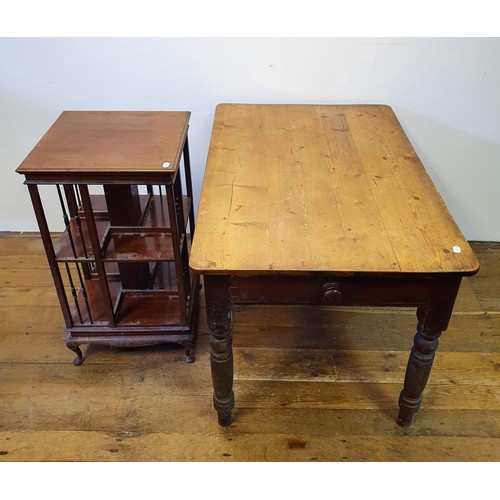 596 - An early 20th century mahogany revolving bookcase, 88 cm high, a pine kitchen table, 125 cm wide, an... 