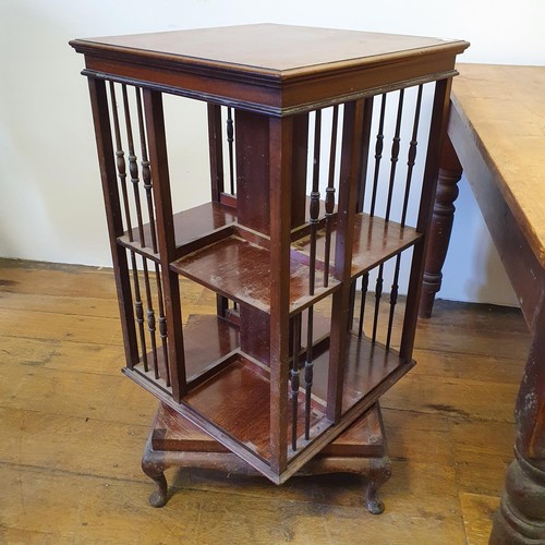 596 - An early 20th century mahogany revolving bookcase, 88 cm high, a pine kitchen table, 125 cm wide, an... 