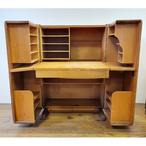 603 - A mid 20th century oak folding desk, with two drawers revealing various compartments, 84 cm wide, a ... 