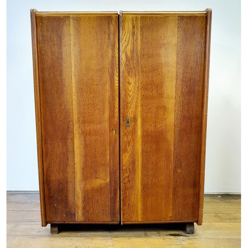 603 - A mid 20th century oak folding desk, with two drawers revealing various compartments, 84 cm wide, a ... 