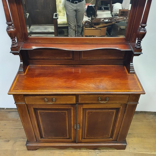 566 - A mahogany sideboard, with a mirrored back, 107 cm wide