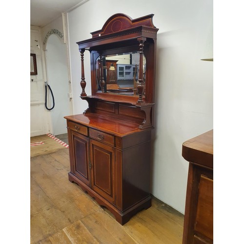 566 - A mahogany sideboard, with a mirrored back, 107 cm wide