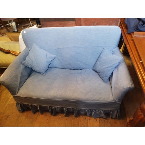 577 - A blue two seater sofa, 135 cm wide, and a gilt oval mirror (2)