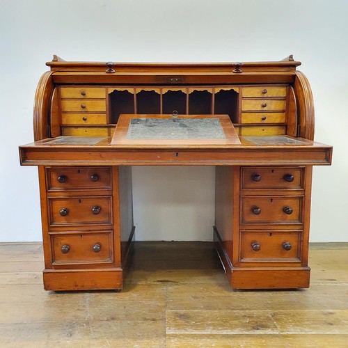 488 - A 19th century mahogany cylinder desk, with a fitted interior, on a base with six drawers, 122 cm wi... 