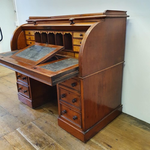 488 - A 19th century mahogany cylinder desk, with a fitted interior, on a base with six drawers, 122 cm wi... 