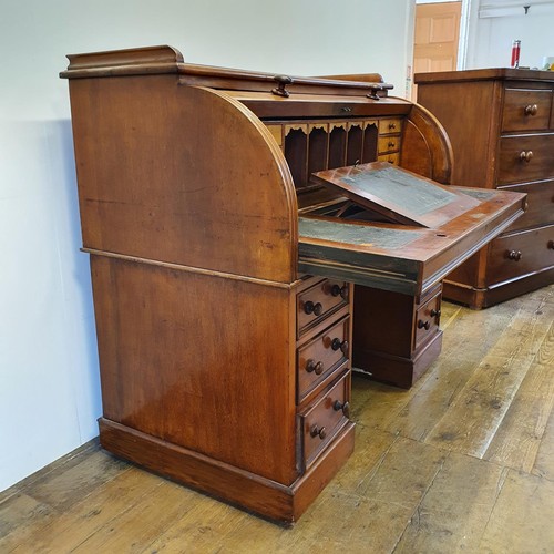 488 - A 19th century mahogany cylinder desk, with a fitted interior, on a base with six drawers, 122 cm wi... 