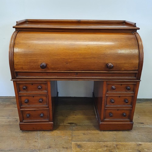 488 - A 19th century mahogany cylinder desk, with a fitted interior, on a base with six drawers, 122 cm wi... 