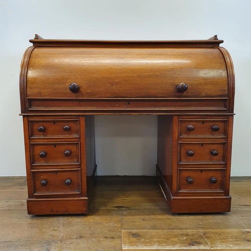 488 - A 19th century mahogany cylinder desk, with a fitted interior, on a base with six drawers, 122 cm wi... 