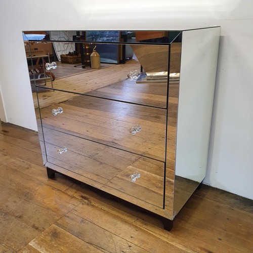 517 - A mirrored chest of three long drawers, 100 cm wide