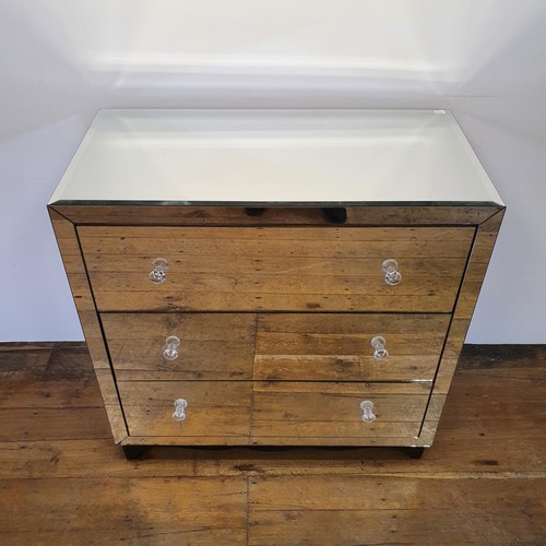 517 - A mirrored chest of three long drawers, 100 cm wide