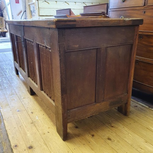 564 - A large oak coffer, with linen fold decoration, 170 cm wide