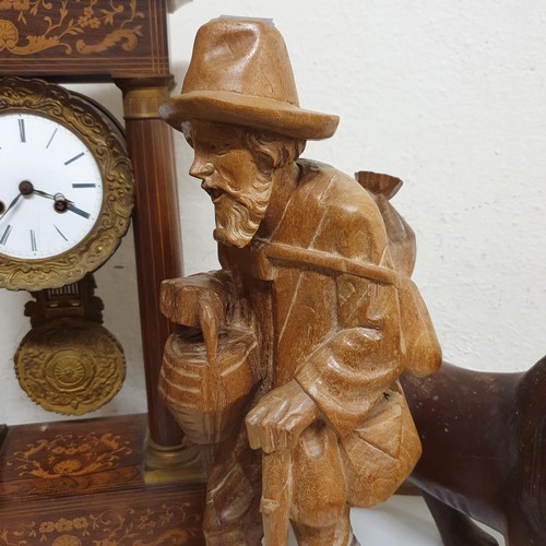 311 - A portico clock, in a rosewood case, 50 cm high, a carved figure of a man, 47 cm high, and a carved ... 