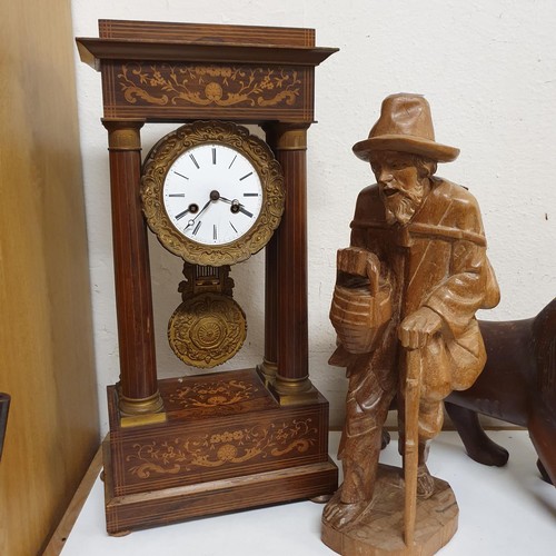 311 - A portico clock, in a rosewood case, 50 cm high, a carved figure of a man, 47 cm high, and a carved ... 