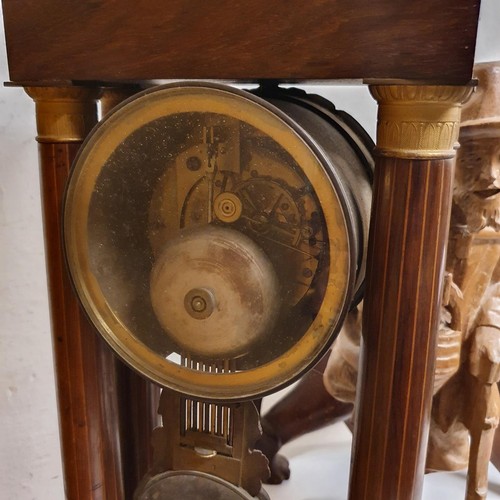 311 - A portico clock, in a rosewood case, 50 cm high, a carved figure of a man, 47 cm high, and a carved ... 