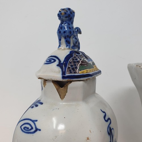 313 - A Delft polychrome vase and cover, 25 cm high, and a similar vase, 19 cm high  (2)