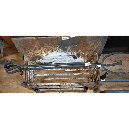 608 - A pair of cast iron fire dogs, 42 cm high, four spark guards, a fire surround, a fire basket and a p... 