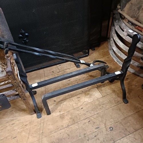 608 - A pair of cast iron fire dogs, 42 cm high, four spark guards, a fire surround, a fire basket and a p... 