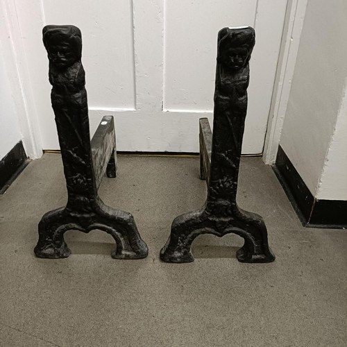 611 - A large pair of 17th century style cast iron fire dogs, 83 cm high