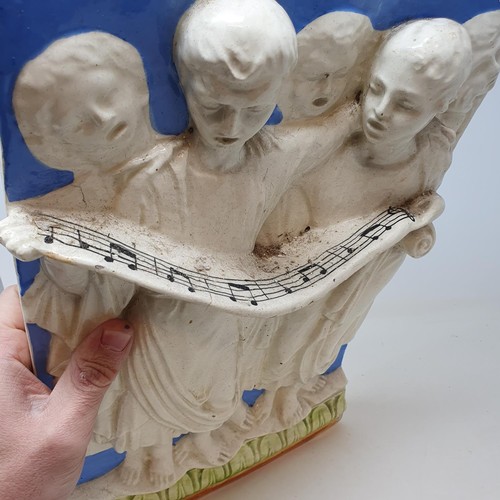 324 - A Continental pottery wall plaque, decorated choristers, 40 x 27 cm