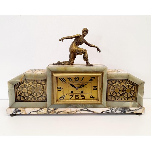 369 - An Art Deco mantel clock, with a finial figure, in a marble case, 62 cm wide