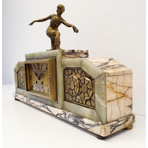 369 - An Art Deco mantel clock, with a finial figure, in a marble case, 62 cm wide