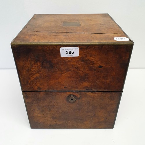 386 - A 19th century walnut decanter box, fitted with four decanters, 25 cm wide