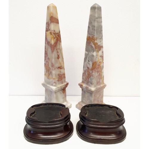 388 - A pair of pink marble obelisks, 33 cm high, and a pair of wooden stands (4)