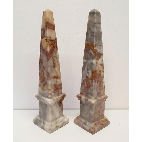 388 - A pair of pink marble obelisks, 33 cm high, and a pair of wooden stands (4)