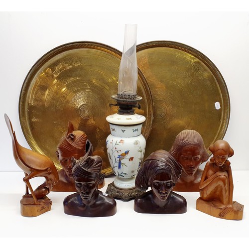 411 - A late Victorian table oil lamp, six carved wood figures, and two large brass trays (9)