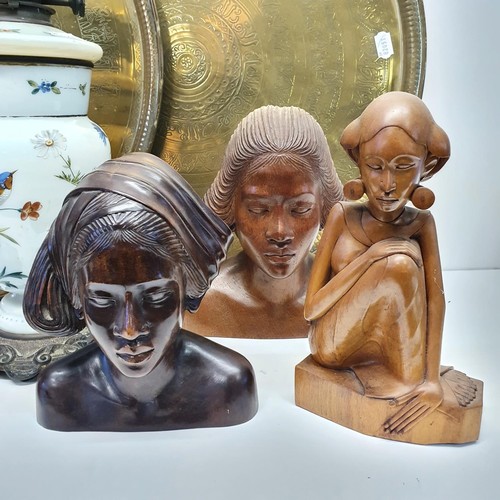 411 - A late Victorian table oil lamp, six carved wood figures, and two large brass trays (9)