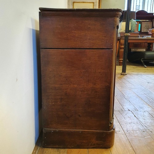 643 - An oak dresser base, having three drawers, flanked by two cupboard doors, 165 cm wide