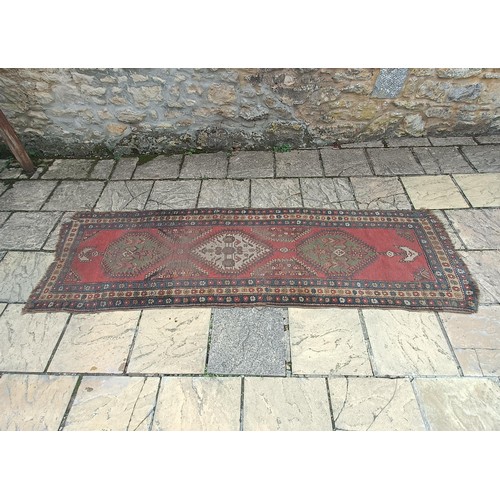 534 - A Persian red ground runner, 300 x 100 cm