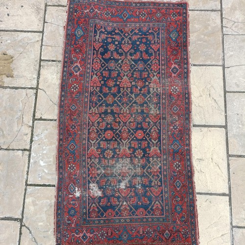 535 - A Persian red ground rug, 189 x 100 cm