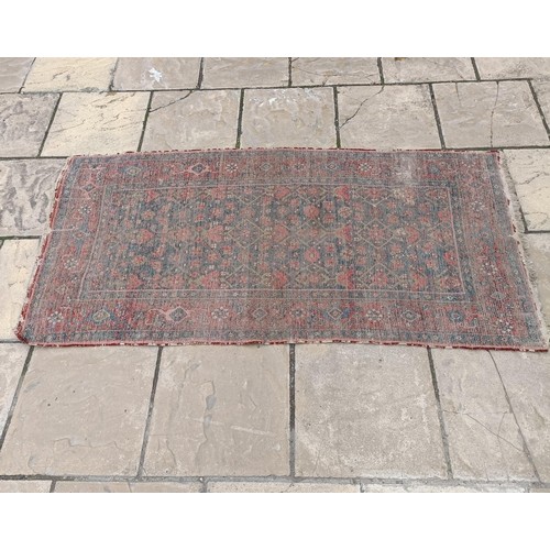 535 - A Persian red ground rug, 189 x 100 cm