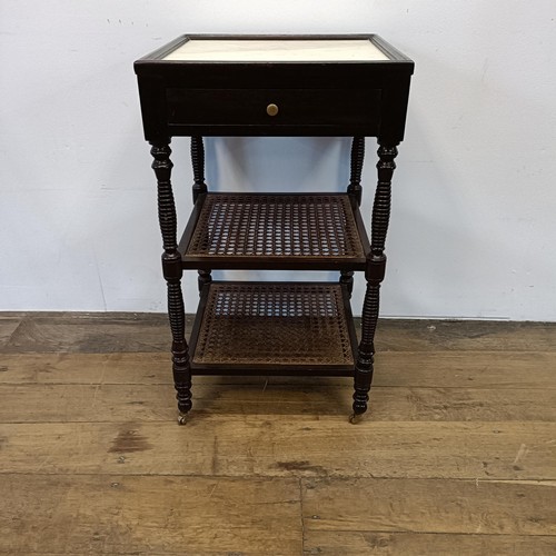 497 - A mahogany two tier bedside table, with a marble top, 43 cm wide