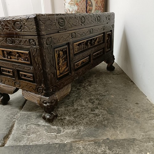 518 - A Chinese carved camphorwood box, 70 cm