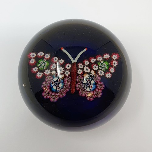 413 - A glass paperweight, decorated a butterfly, 7.5 cm diameter