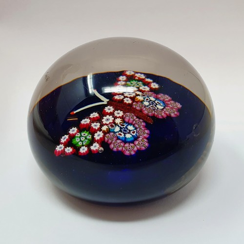 413 - A glass paperweight, decorated a butterfly, 7.5 cm diameter