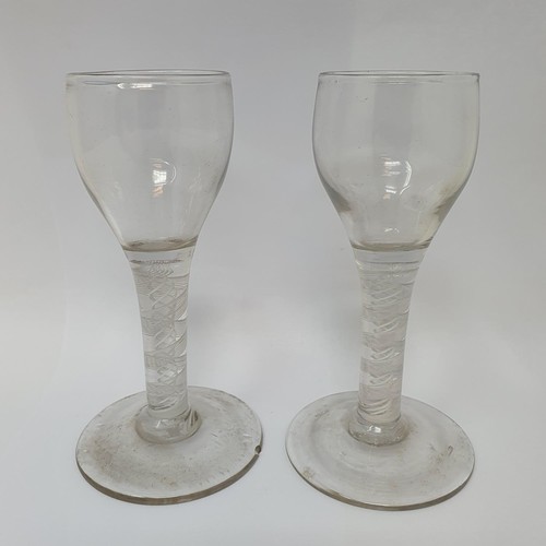 416 - A near pair of cordial glasses, with double cotton twist stems, 12.5 cm high, one with a foot rim ch... 