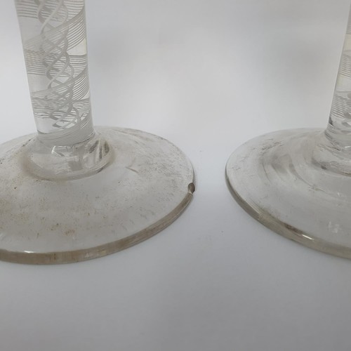 416 - A near pair of cordial glasses, with double cotton twist stems, 12.5 cm high, one with a foot rim ch... 