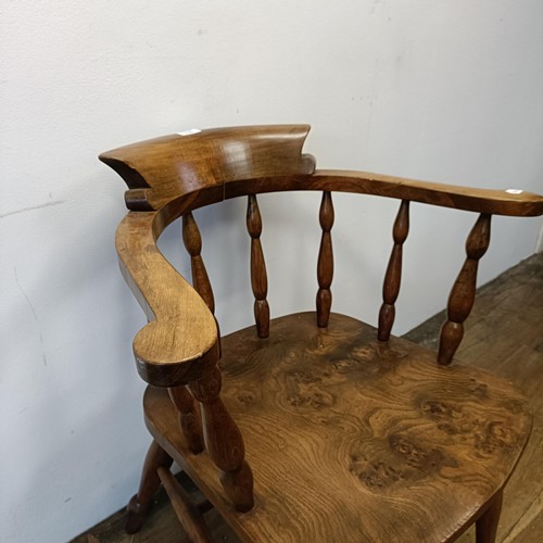 528 - An elm smoker's bow armchair