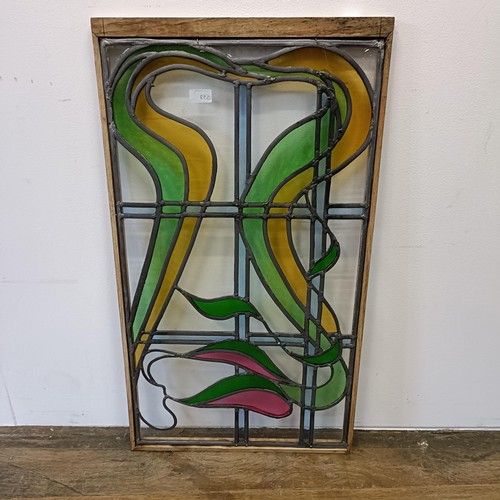 558 - A stained glass panel, 85 x 46 cm, an oval mirror, and two other mirrors (4)